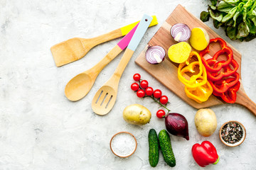 Fresh food ingredients for vegetarian kitchen on white stone background top view