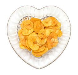 Banana chips in glass bowl  on white background