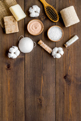 Organic cosmetics and eco materials for homemade spa on wooden background top view mock up