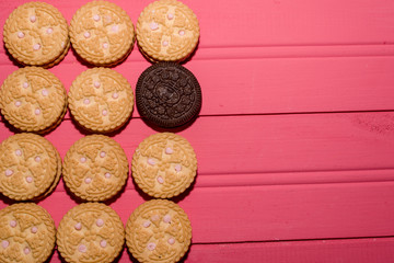 strawberry-flavored cream-filled cookies together with chocolate cookie