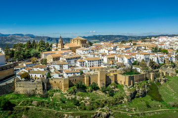 Ronda Spain aerial view of medieval hilltop town surrounded by walls and towers with famous bridge...