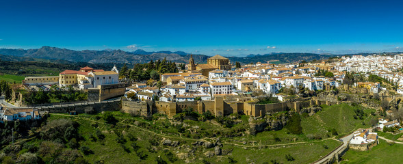 Ronda Spain aerial view of medieval hilltop town surrounded by walls and towers with famous bridge over gorge