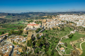 Fototapeta na wymiar Ronda Spain aerial view of medieval hilltop town surrounded by walls and towers with famous bridge over gorge