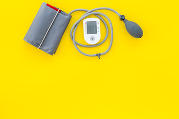 cardiologist work desk with pulsimeter on yellow background top view mock up