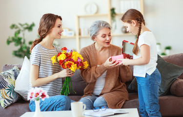 mother's day! three generations of  family mother, grandmother and daughter congratulate on the...