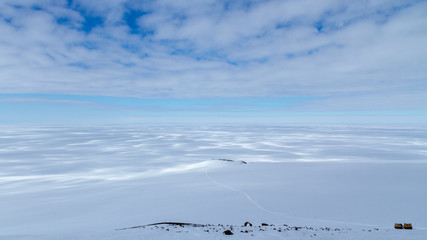 A Haaglunds or over-snow vehicle on the Ross Ice Shelf with expansive view of Antarctica © James Stone
