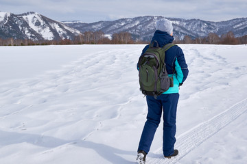 Woman with backpack hiking Lifestyle adventure concept forest and mountains on background active vacations into the wild
