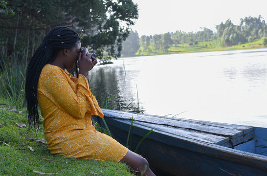 woman sitting with a camera in Kenya