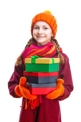 Smiling Happy Caucasian Little Girl In Orange Beanie, Scarf and Mittens With Pile of Colorful Giftboxes. Isolated Against Pure White Background.