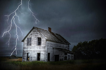 heavy lightning  and thunder storm close to abandoned house.