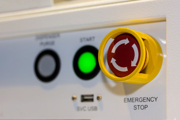 Close up emergency stop button on control panel of machine for safety at factory
