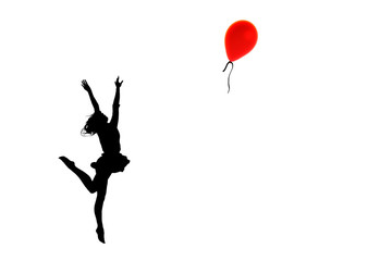 Silhouette of a girl, in the pose of a jumping ballerina behind a red balloon, with outstretched arms in the form of wings.