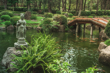 Japanese garden with an asian statue, lake and bridge located in Colomos forest in Guadalajara, Mexico