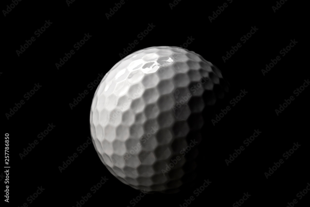 Poster high contrast studio shot of golf ball isolated on black background with dramatic light