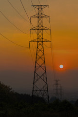 Silhouette high voltage pole at sunset