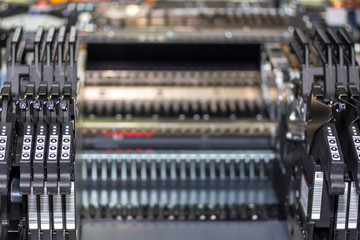 close up automatic component feed unit of PCB LED SMT pick and place machine feeder for assembly...