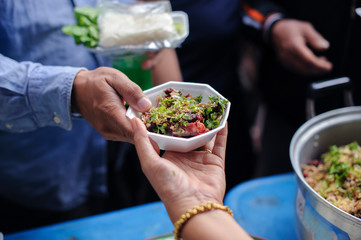 Food support: People are handing over food from volunteers with philanthropists to support cooking.