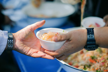 Obraz premium Charity concept : Feeding the poor to help each other in society.