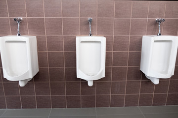 White urinals in men public toilet