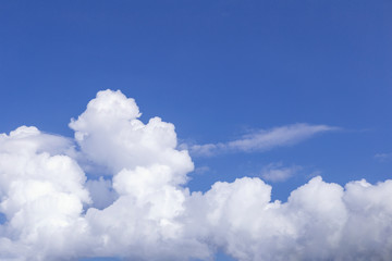Blue sky background with white clouds, rain clouds on sunny summer or spring day.