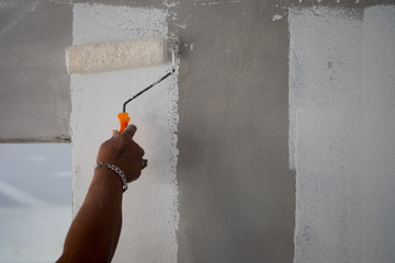 Painting color on building wall. Apartment renovation. © Dontree