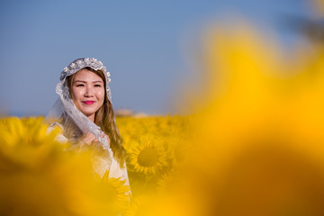 asian woman at sunflower field