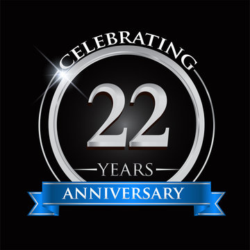 Celebrating 22 years anniversary logo. with silver ring and blue ribbon.