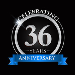 Celebrating 36 years anniversary logo. with silver ring and blue ribbon.