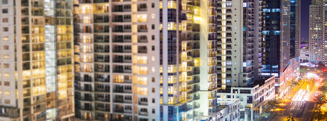 Fototapeta na wymiar Apartment windows at night. Wide angle panorama.