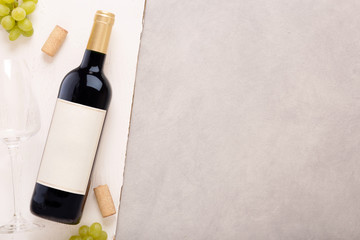 Bottle of white wine with label. Glass of wine and cork. Wine bottle mockup.
