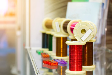 many new of colorful wire coil on table with flare for electric industrial work