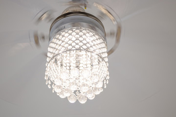 The light from the chandelier hanging from the ceiling.