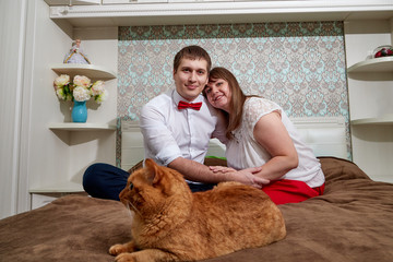 Couple consisting of a handsome man and a fat woman in the room