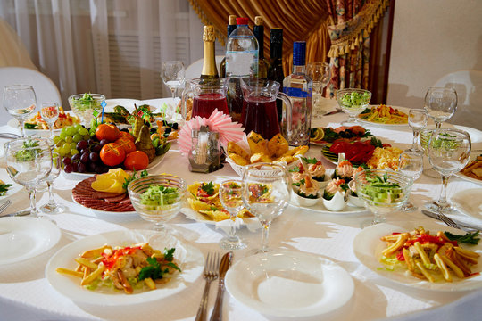 Food and bottle with alcohol on a banquet served table