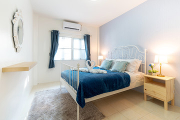 bedroom of the house or home with cozy bed , swan towel , high raised ceiling and blue blanket , interior design real estate 