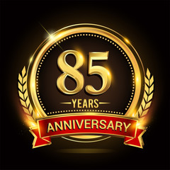 Celebrating 85th years anniversary logo with golden ring and red ribbon.