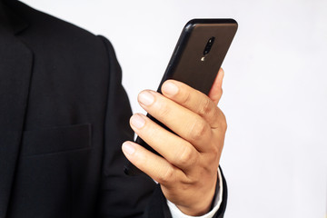 Male hand holding a  smartphone on white background, business concept.