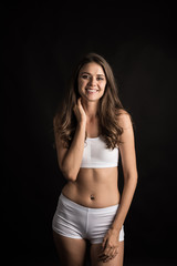 Fototapeta premium Beautiful woman with healthy body on black background