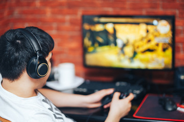Man playing a computer games in headphones and console