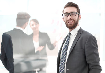 confident businessman in the background of the office