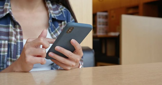 Woman use cellphone order at restaurant