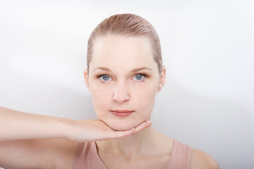 facial gymnastics. the girl does massage and rejuvenating exercises for the face