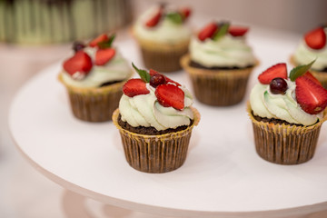 Wedding cake with flowers, figs, macarons and blueberries