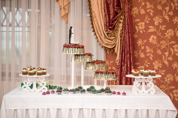 Wedding cake with flowers, figs, macarons and blueberries