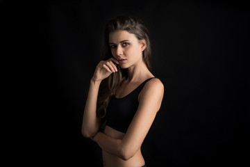 Fototapeta premium Beautiful woman with healthy body on black background