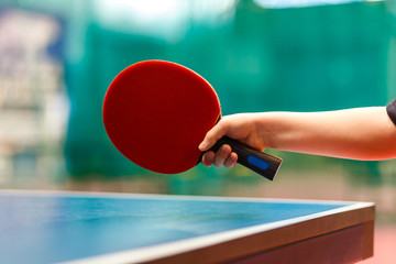 Red tennis racquet in the children's hand