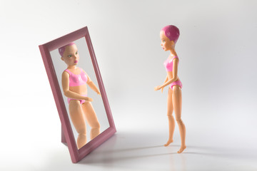 doll with food addiction trying to induce vomiting. Signs, consequences, symptoms and treatment of anorexia. the girl sick Problems with weight, food addiction in women, bulimia and anorexia
