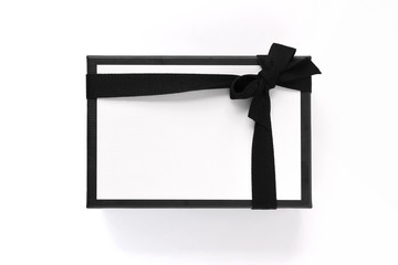 Black & White gift box with black ribbon isolated on white background. Overhead view.