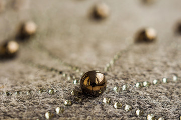 metal bead with reflection lies on the fabric