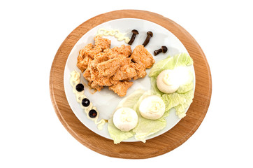 stewed chicken meat in a sauce with mushrooms. Beautiful dish on a white background